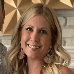 Laura Teal, a white woman with long curled blonde hair.