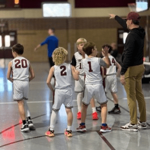 Trojan Hoops boys listening intently to their coach.