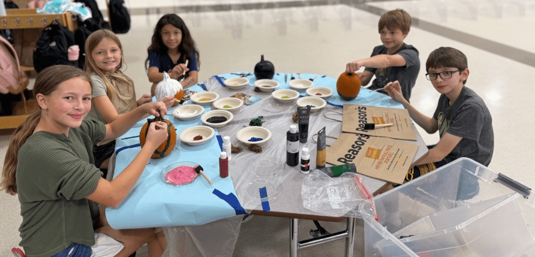 Three girls smiling and hugging.