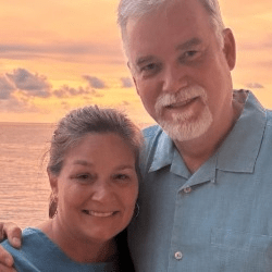 Hands using a sewing machine on a quilt top.