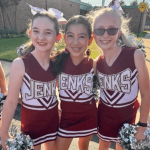 Three Trojan cheer students.