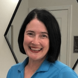 Amy Tuggle, a white woman with short black hair.