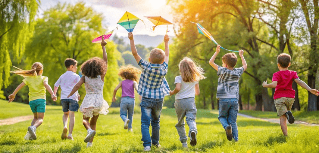 Group of children running with kites on a summer day.