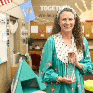 Teenage girl smiling in Scouting America uniform.