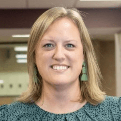 Amy Tuggle, a white woman with short black hair.