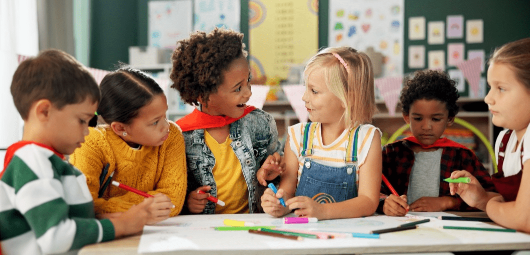 Group of children coloring in a classroom.