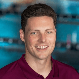 Mitchell Wagner, a man with short brown hair in a maroon polo in front of a pool.